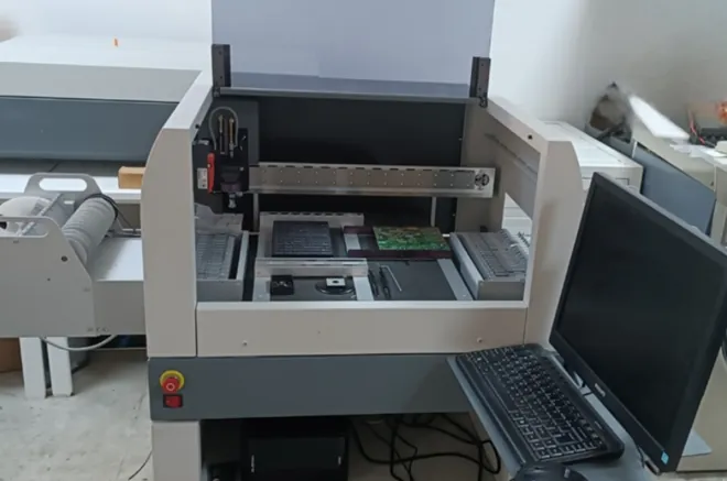 SMT pick-and-place machine in electronics lab